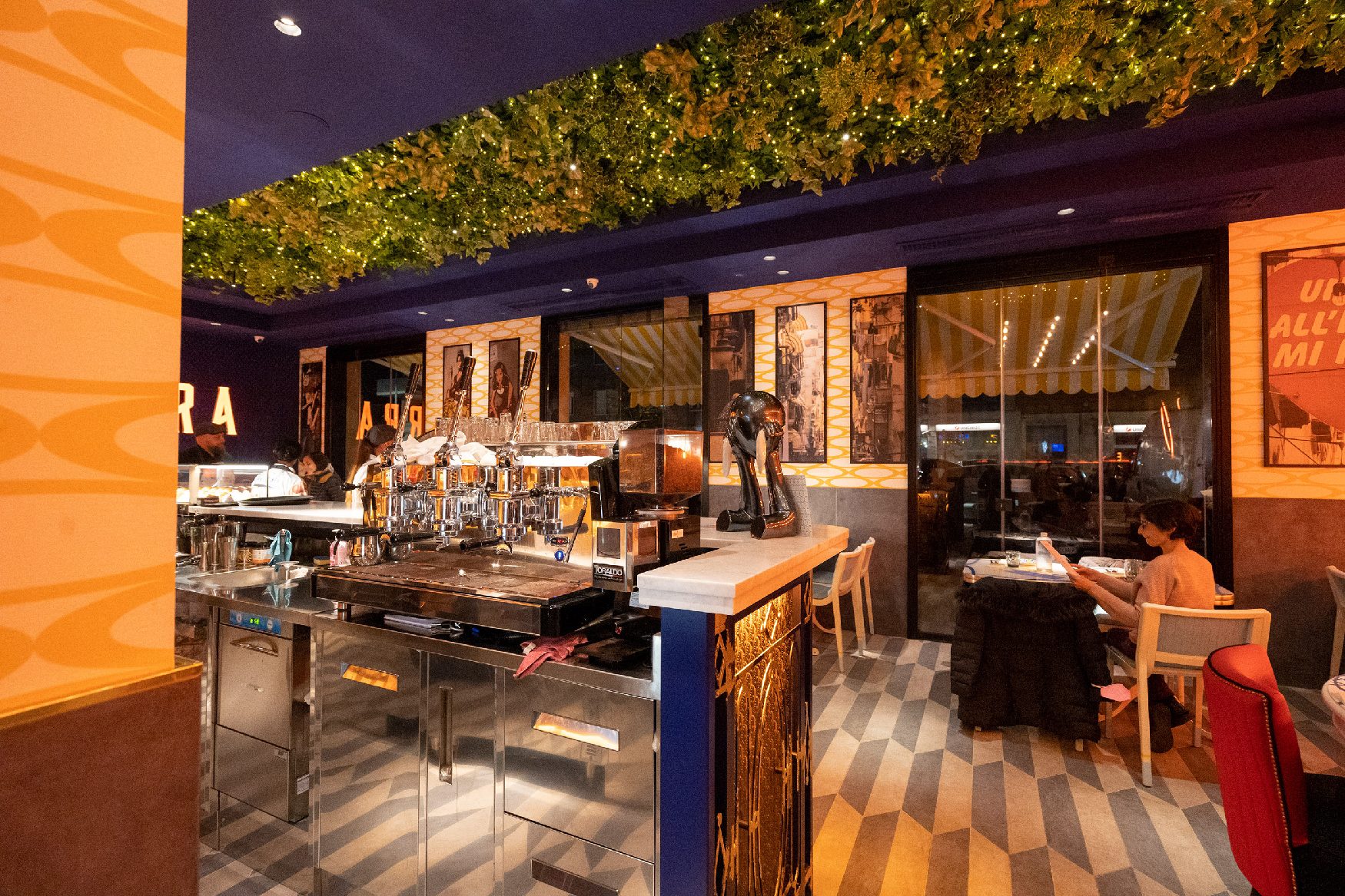 Restaurant interior with plants on the ceiling
