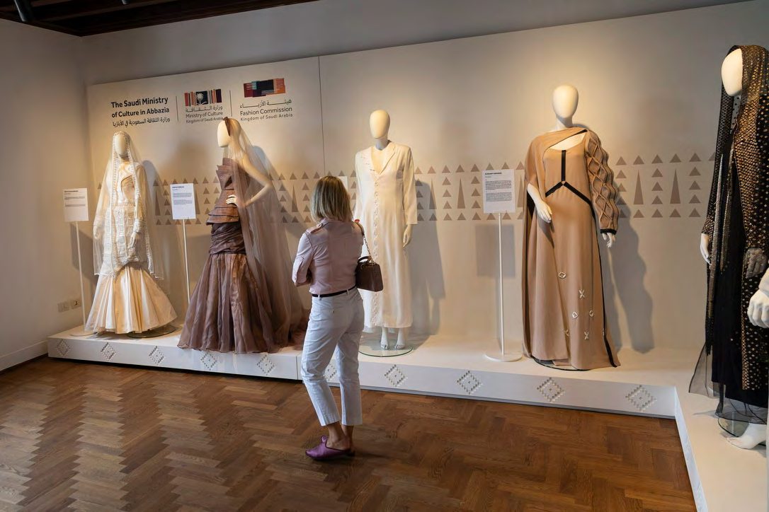Visitor looking at the dresses of the Saudi Fashion Exhibition